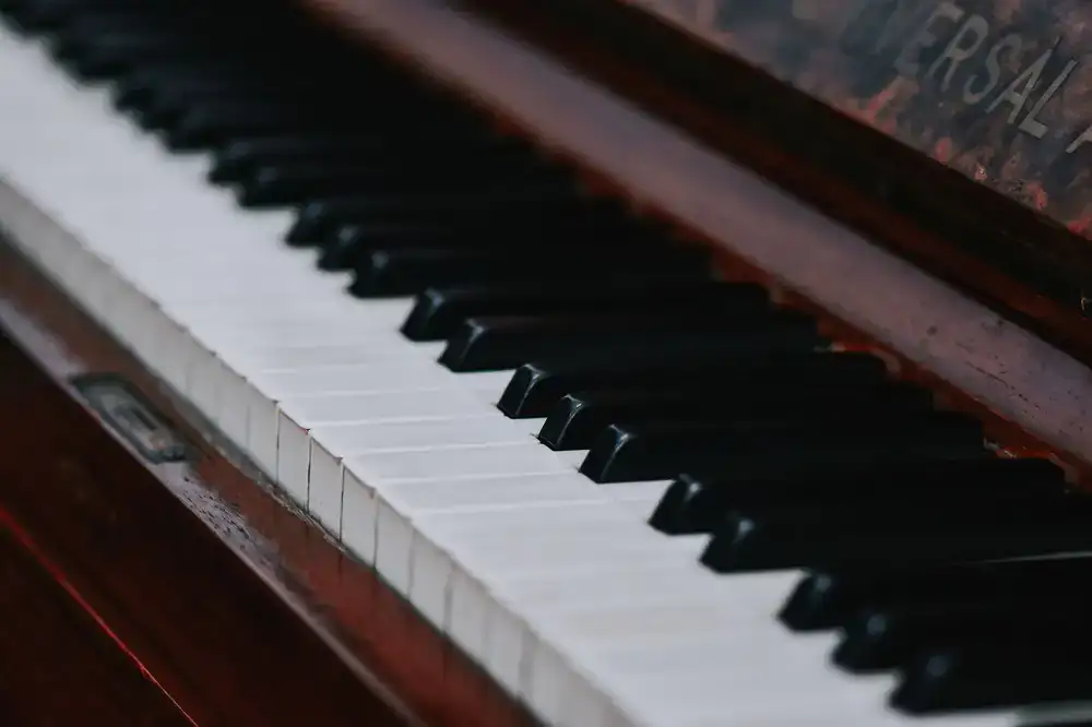 Close-up view of elegant piano keys and rich walnut wood grain