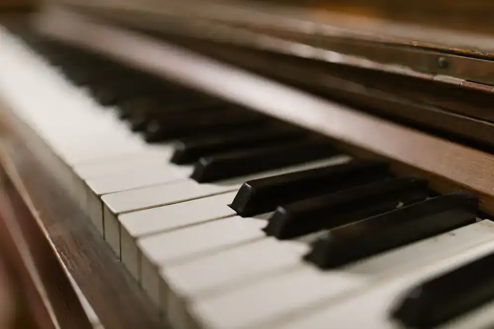 Close up view of piano keys and polished wood finish