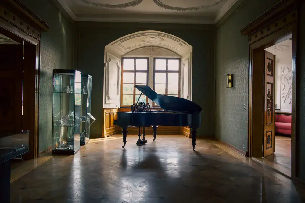 An elegant grand piano displayed in a warmly lit showroom